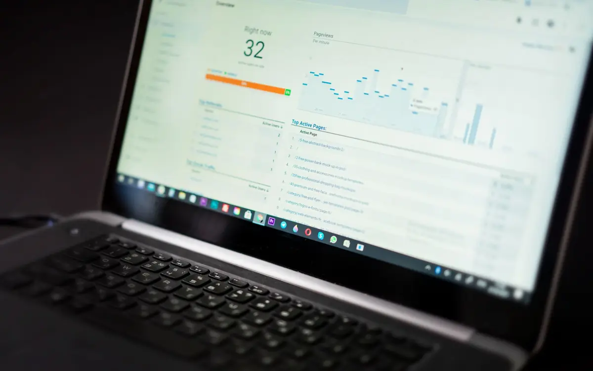Laptop showing an analytics dashboard, used to compare Meta Ads and Google Ads results on a small test budget