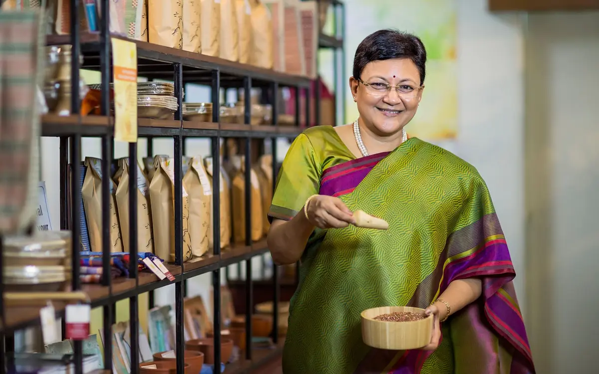 Smiling shop owner in a sari at her store, the business owner who works with a social media agency